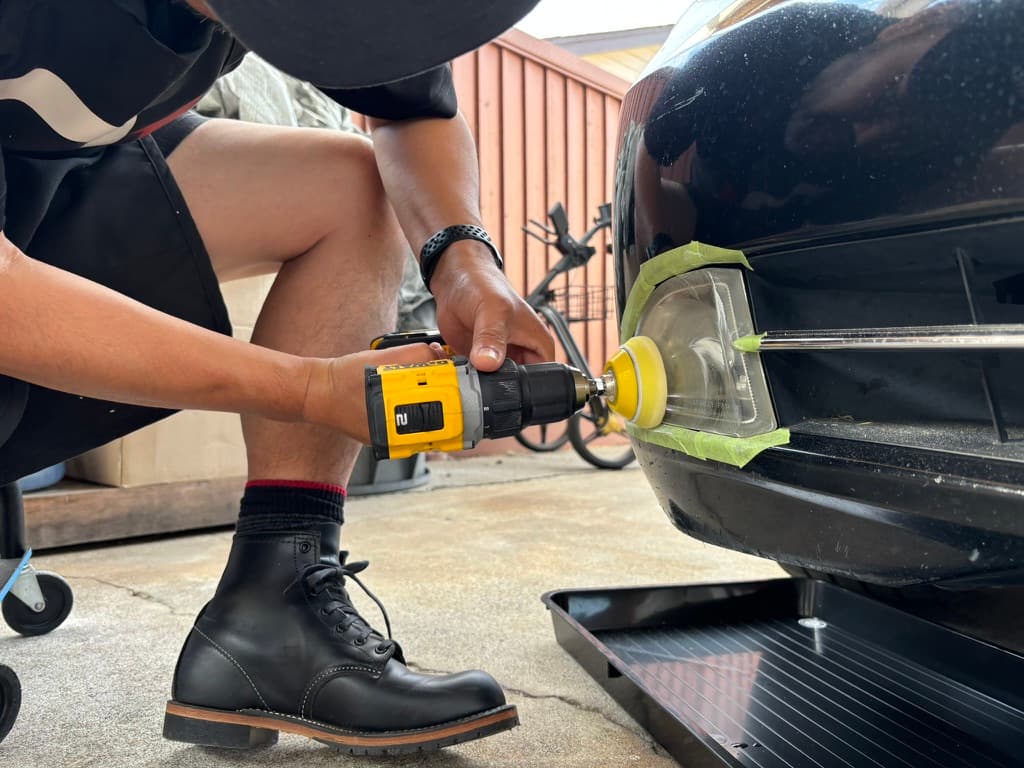 Technician restoring a vehicle's headlight